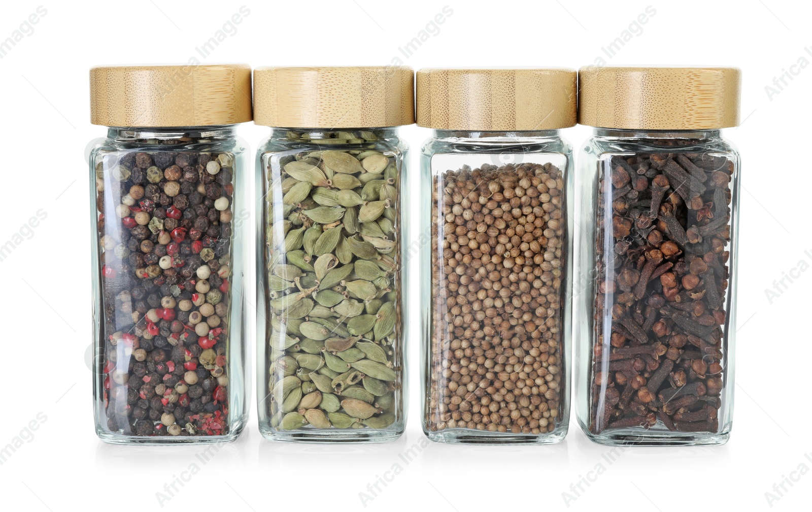 Photo of Different spices in glass jars isolated on white