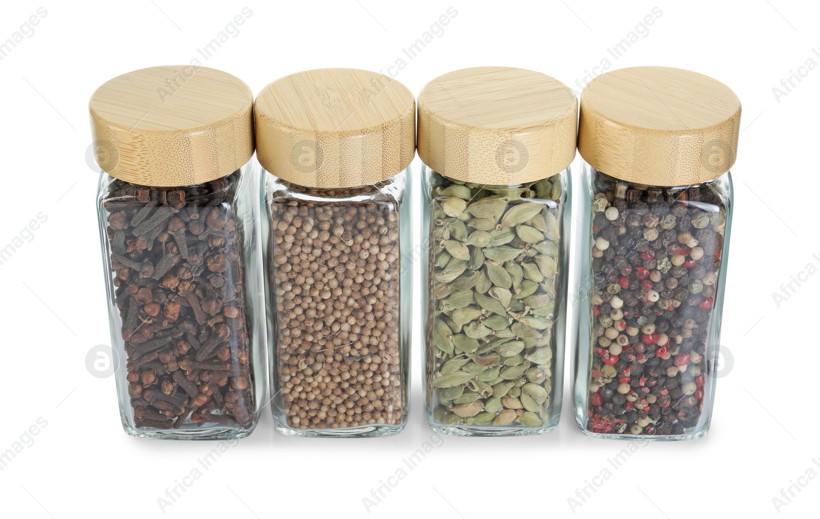 Photo of Different spices in glass jars isolated on white