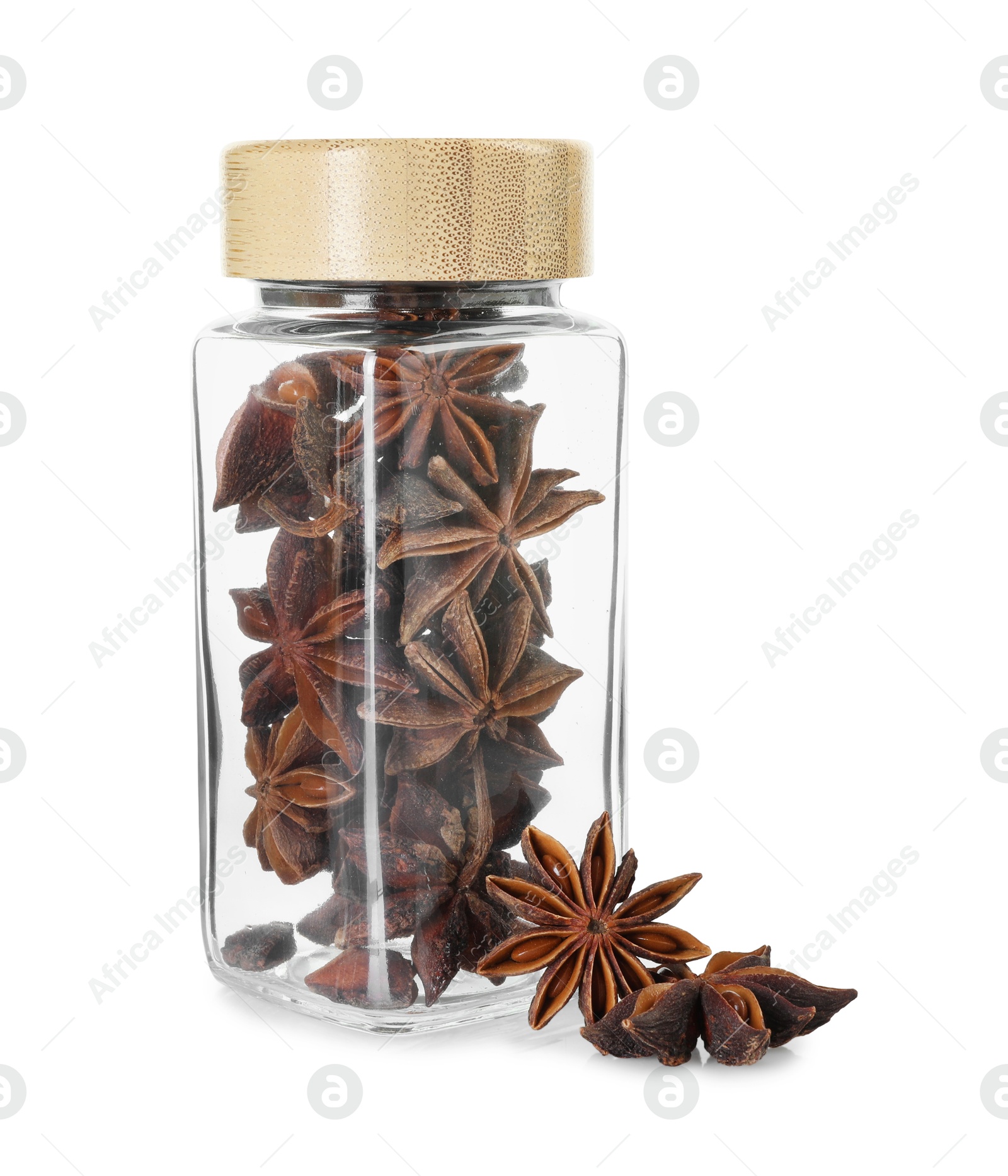 Photo of Anise stars in glass jar isolated on white