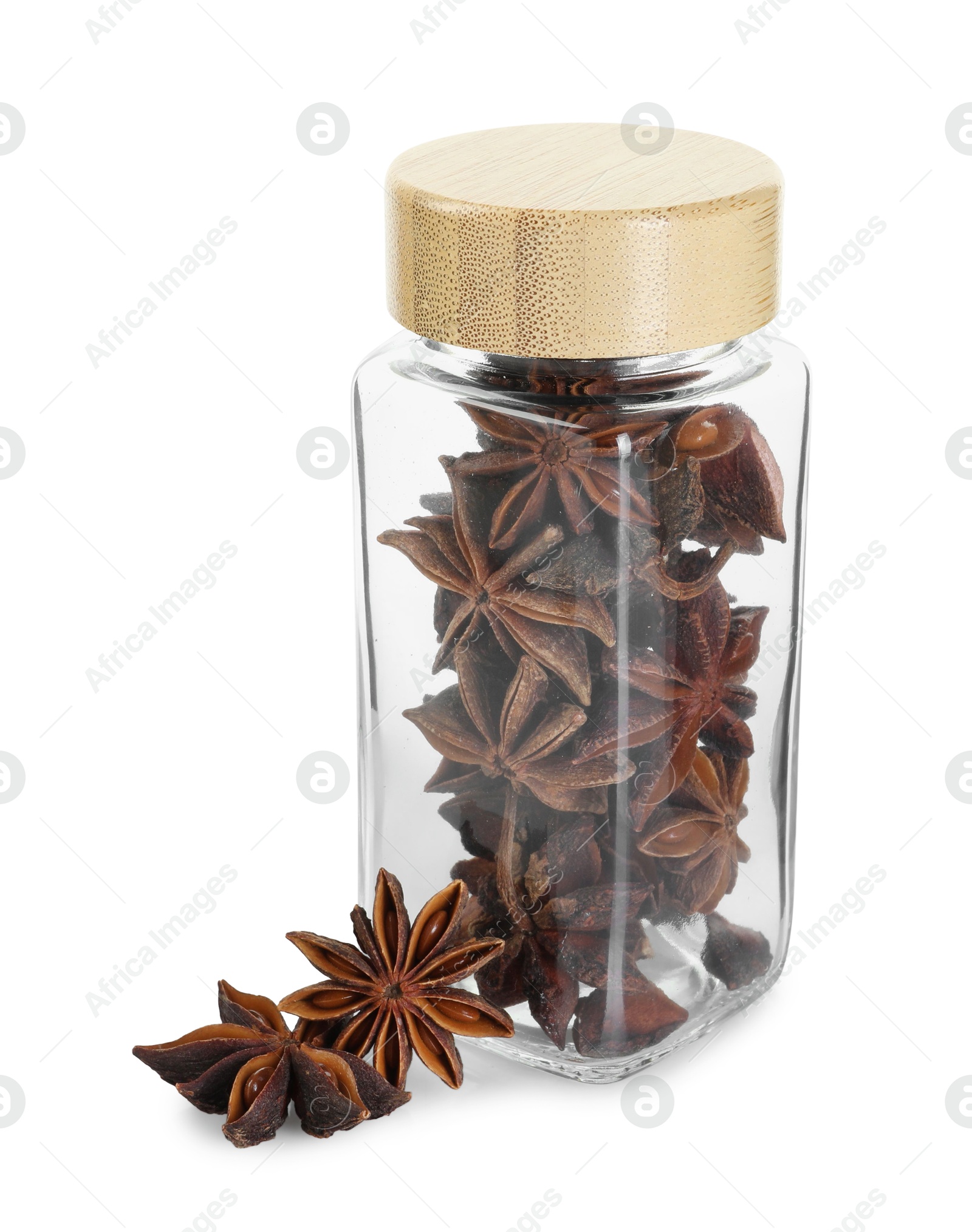 Photo of Anise stars in glass jar isolated on white