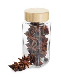 Photo of Anise stars in glass jar isolated on white