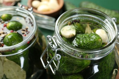 Photo of Making pickles. Fresh cucumbers and spices in jars, closeup