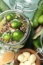 Photo of Making pickles. Fresh cucumbers and spices in jar on table, flat lay