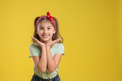 Photo of Portrait of cute girl on yellow background