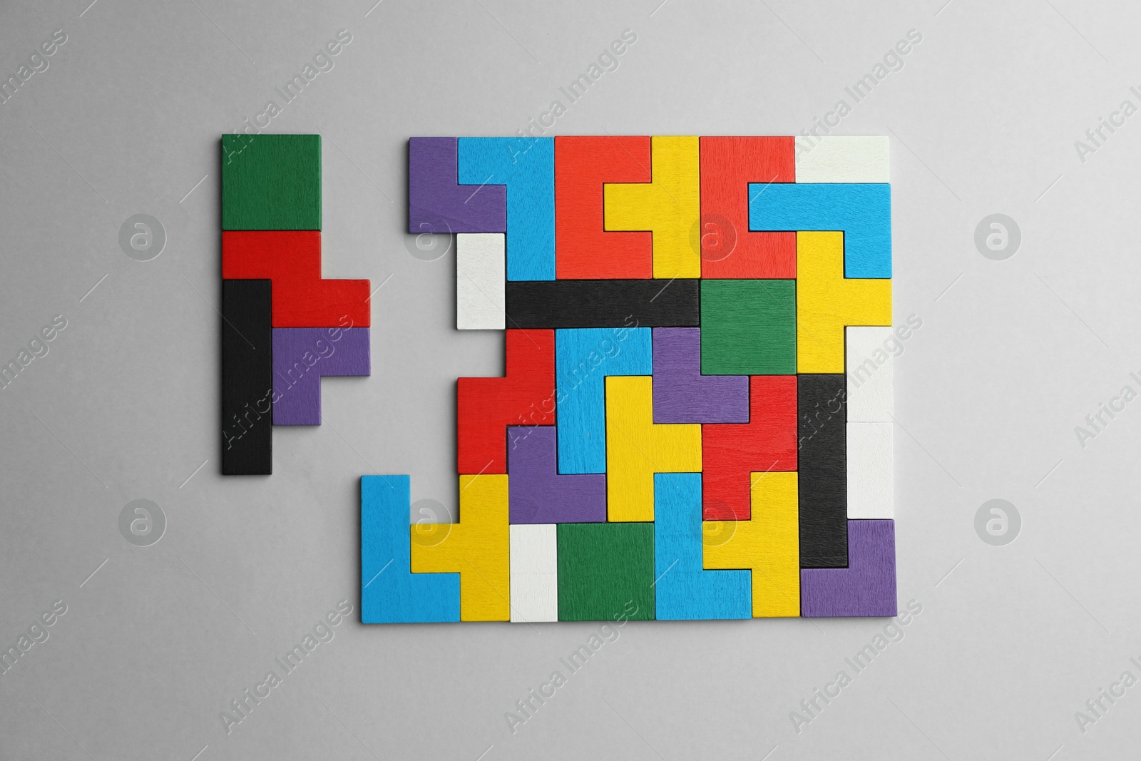 Photo of Colorful wooden puzzle pieces on light grey background, top view