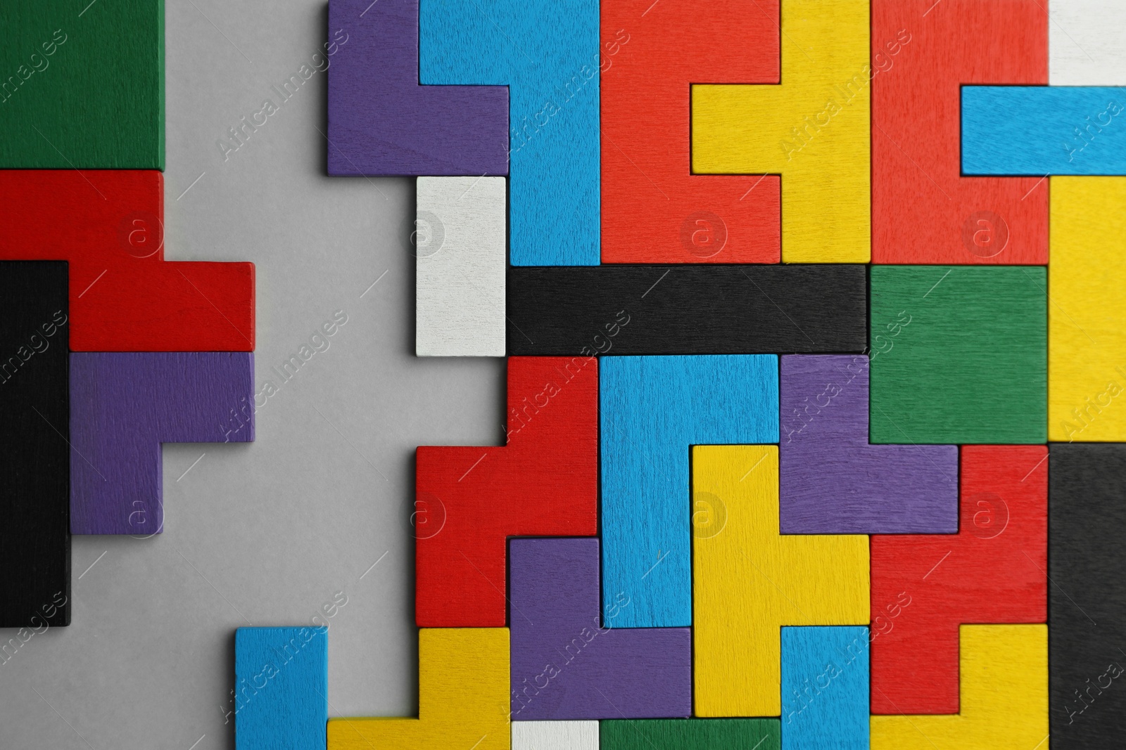 Photo of Colorful wooden puzzle pieces on light grey background, top view