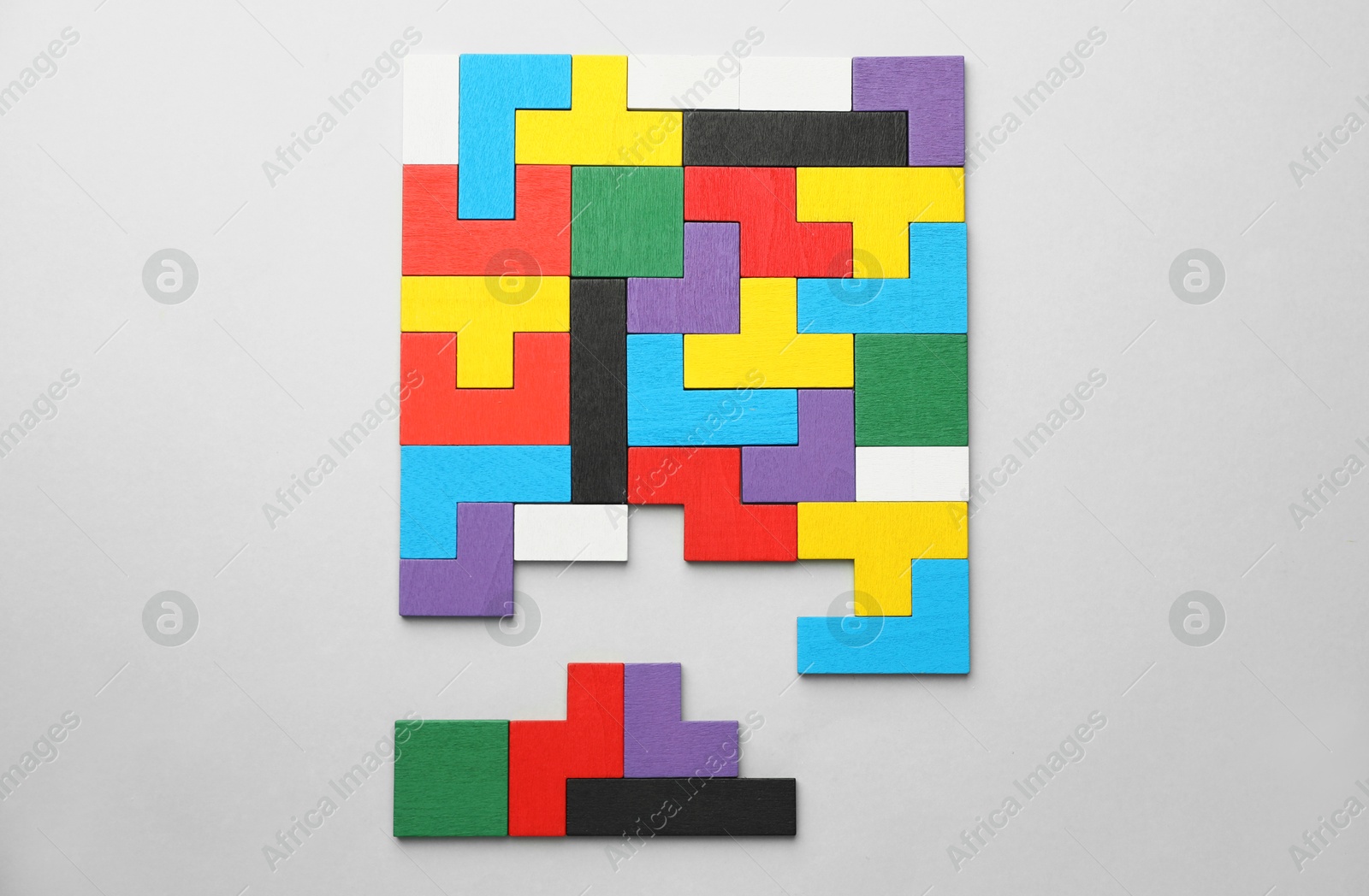 Photo of Colorful wooden puzzle pieces on light grey background, top view