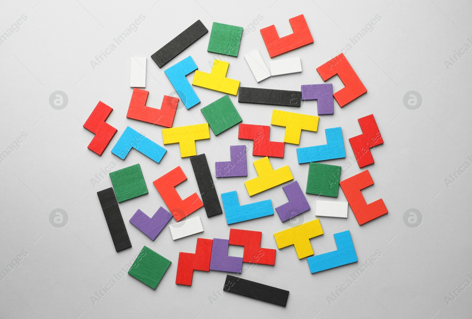 Photo of Colorful wooden puzzle pieces on light grey background, top view