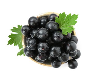 Fresh ripe black currant berries with leaves isolated on white, top view