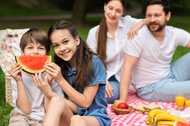 Family picnic. Parents and their children spending time together outdoors, selective focus