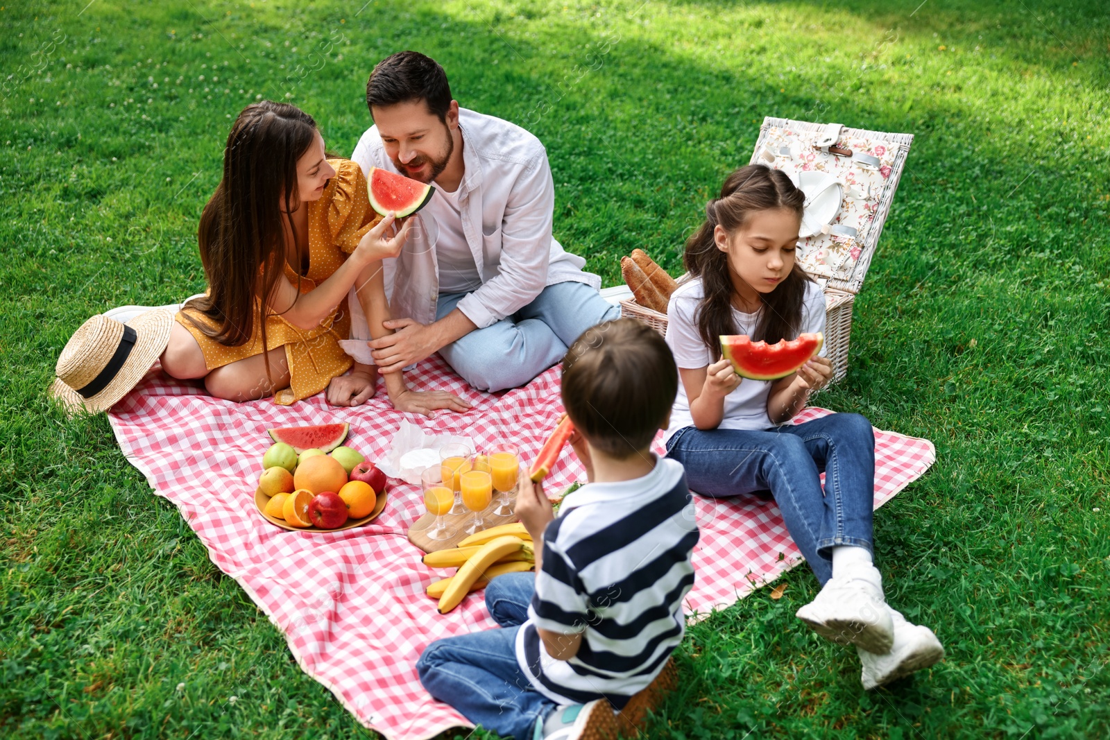 Photo of Happy family having picnic together in park