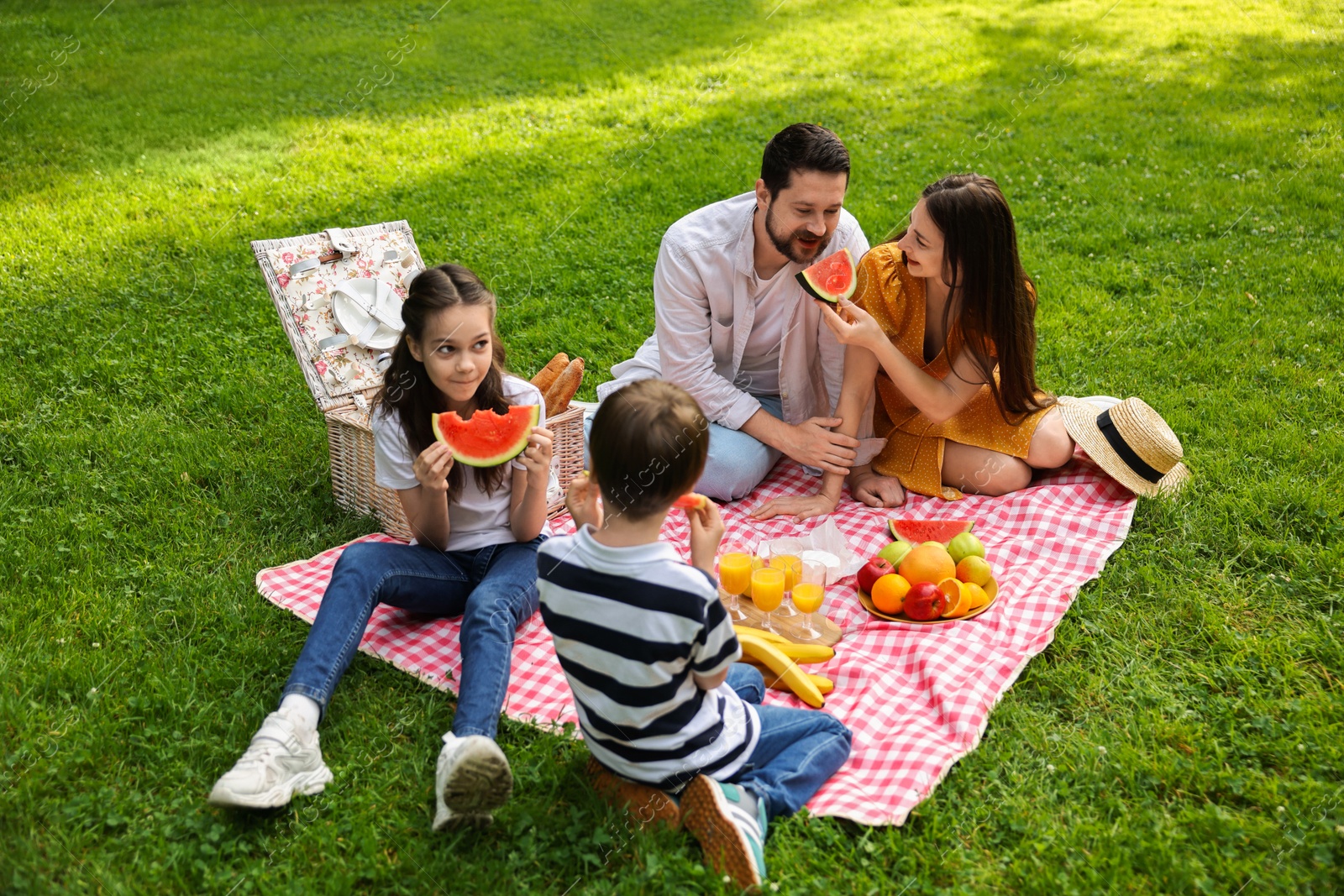 Photo of Happy family having picnic together in park