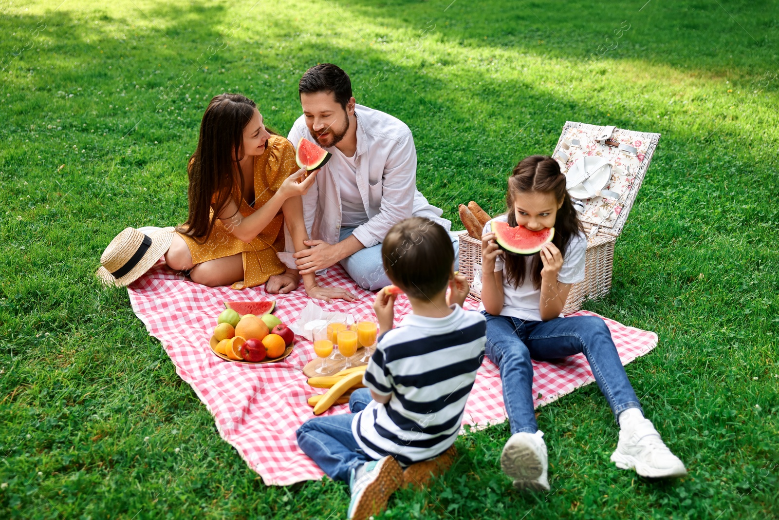 Photo of Happy family having picnic together in park