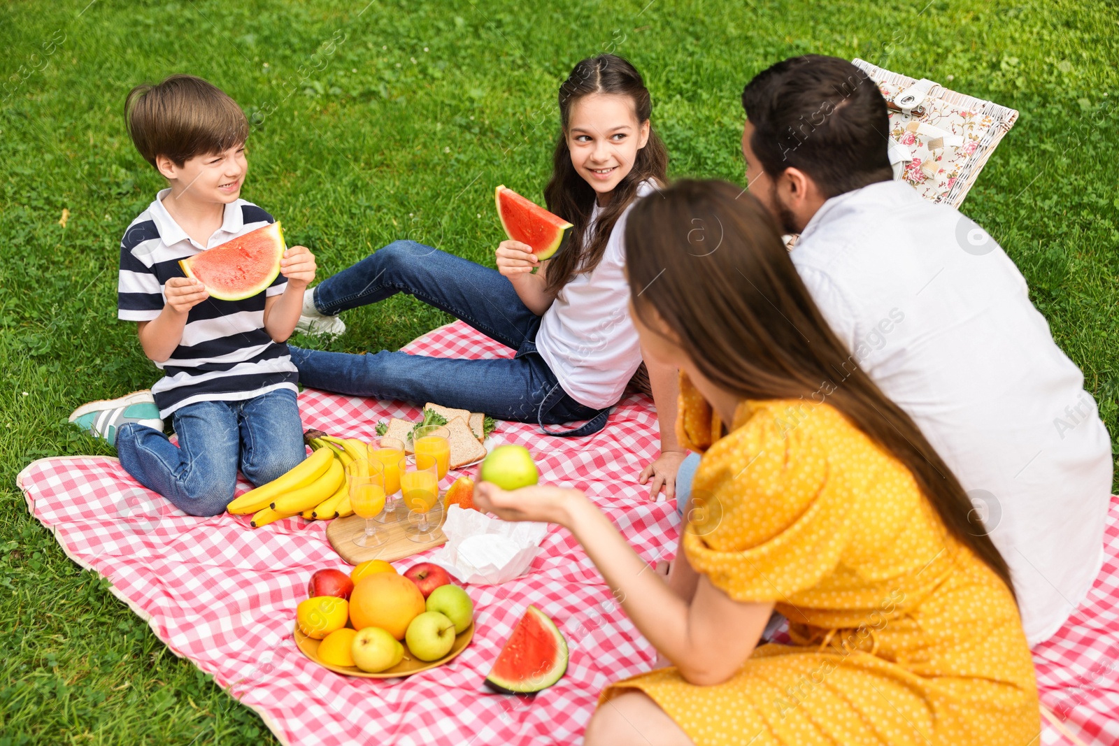 Photo of Happy family having picnic together in park