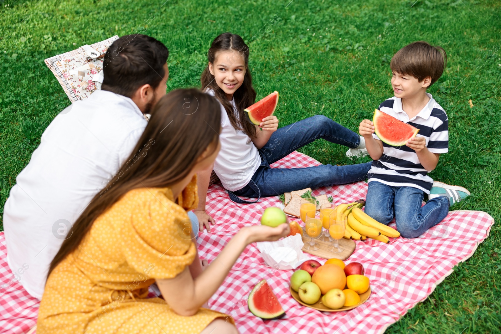 Photo of Happy family having picnic together in park