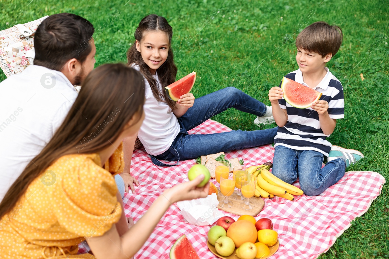 Photo of Happy family having picnic together in park