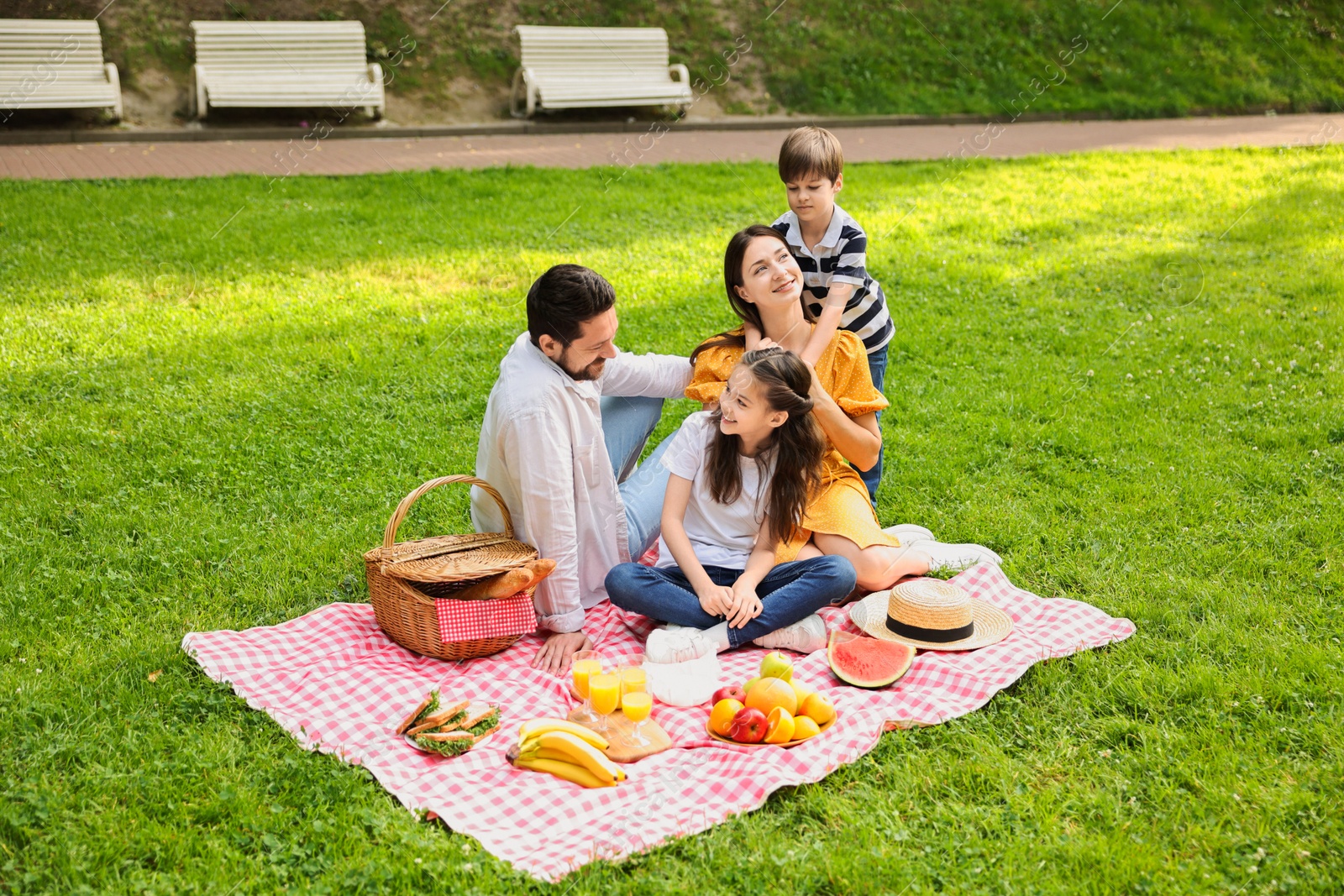 Photo of Happy family having picnic together in park