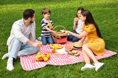 Lovely family having picnic together in park