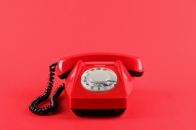 Photo of One telephone with handset on red background