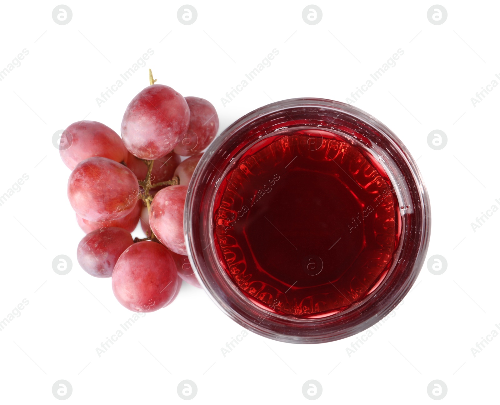 Photo of Tasty grape juice in glass and berries isolated on white, top view