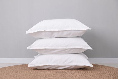 Photo of Stack of white pillows on floor indoors