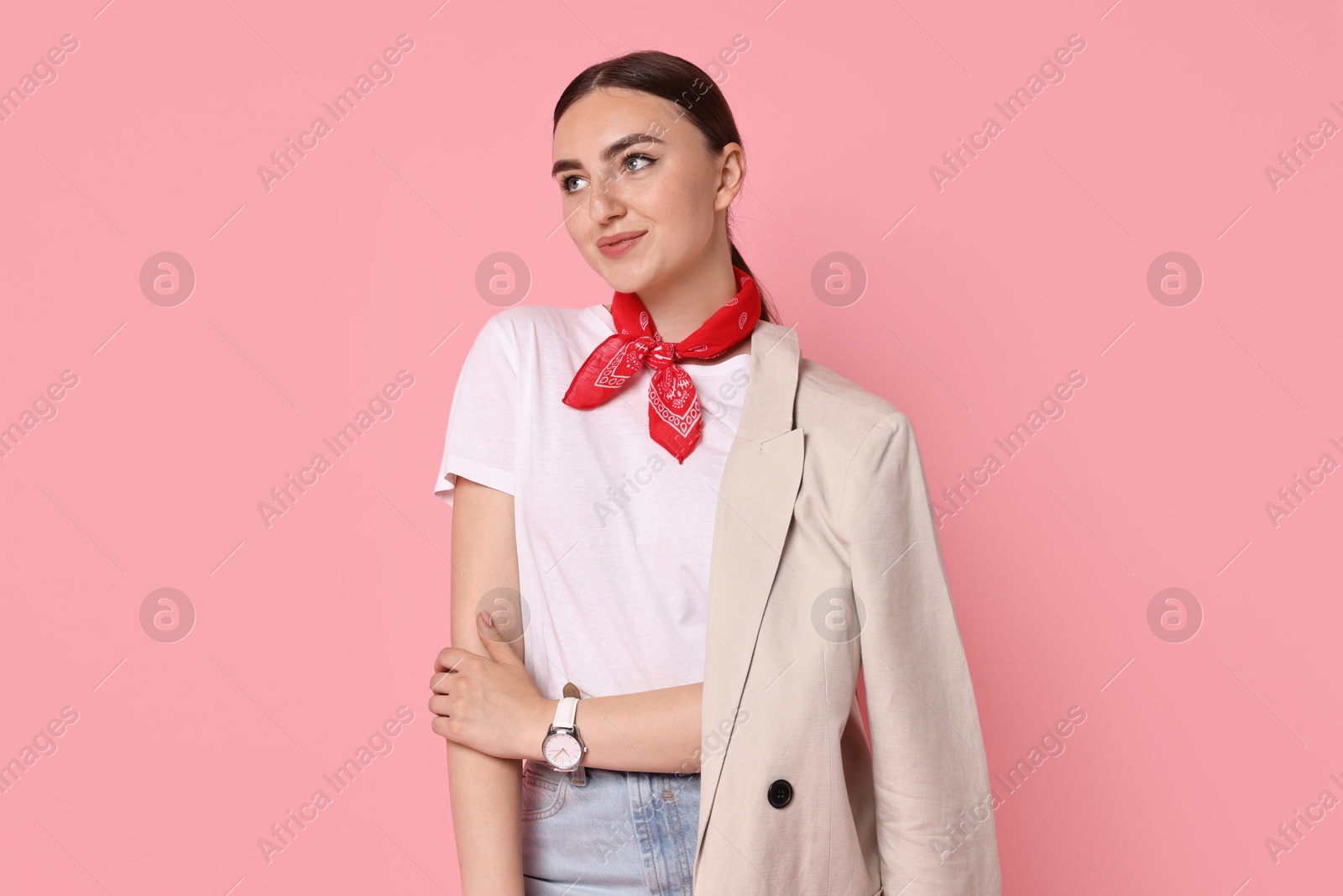 Photo of Stylish woman in beige jacket and jeans on pink background