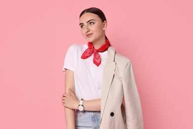 Photo of Stylish woman in beige jacket and jeans on pink background