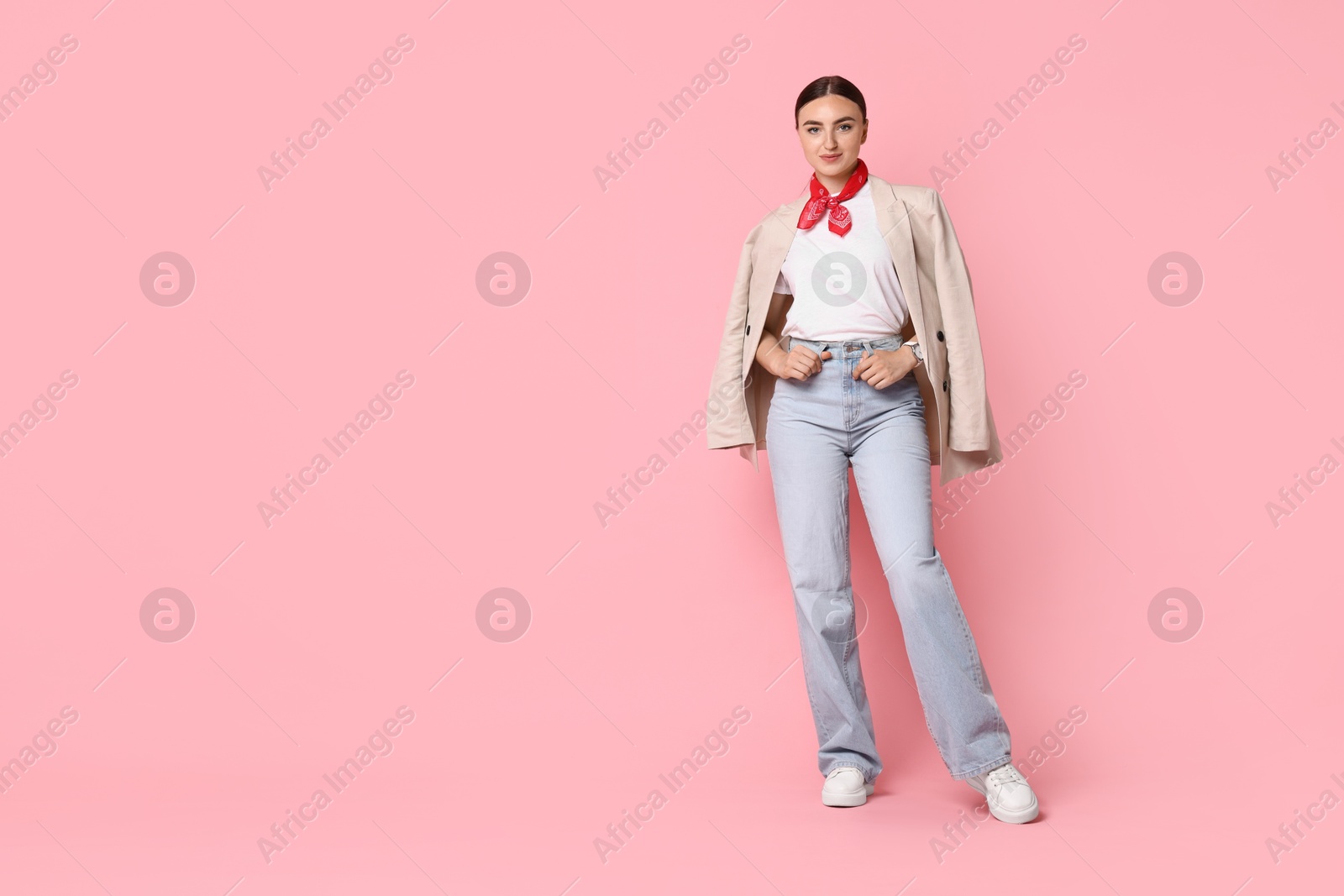 Photo of Stylish woman in beige jacket and jeans on pink background, space for text