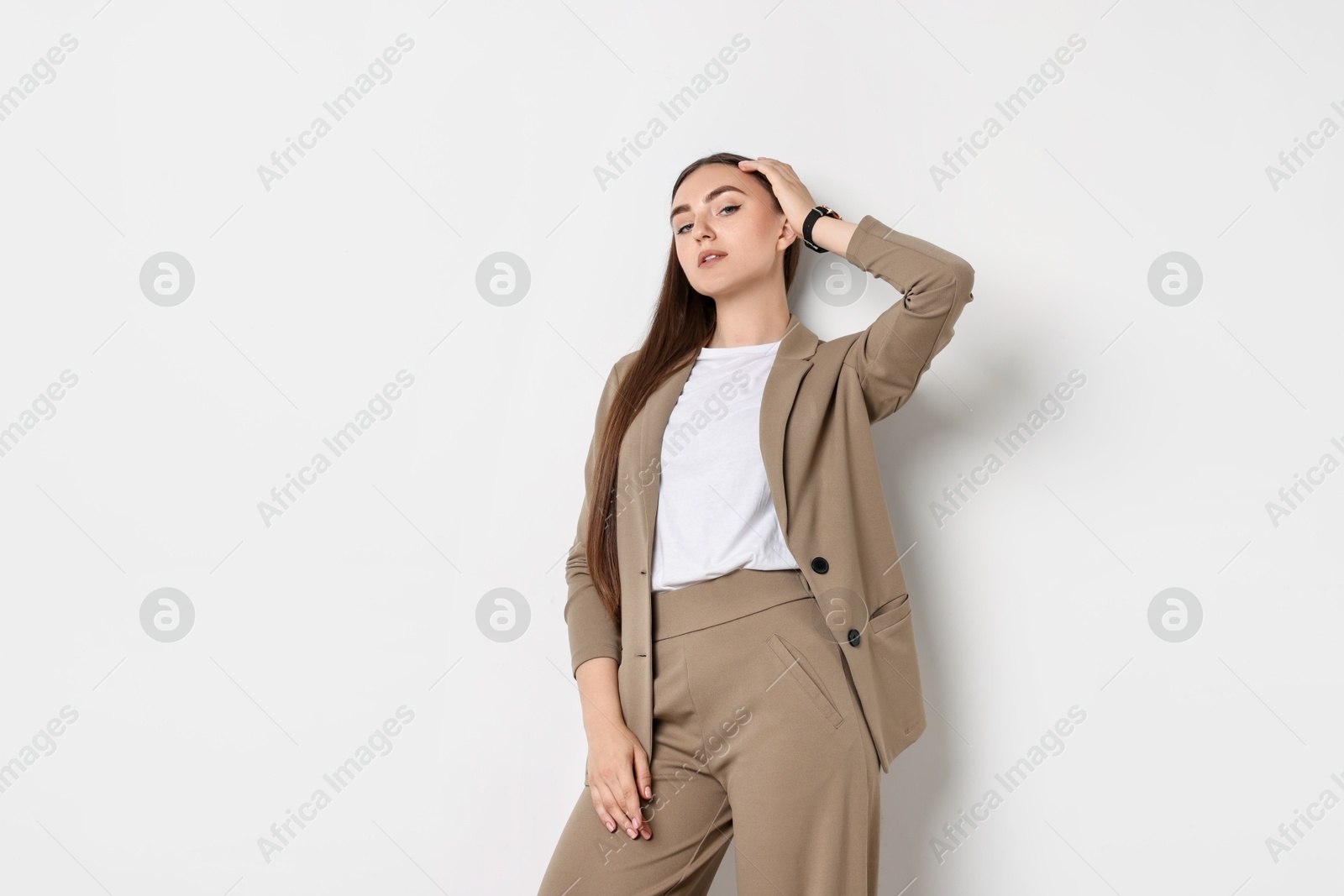 Photo of Beautiful woman in beige suit on white background