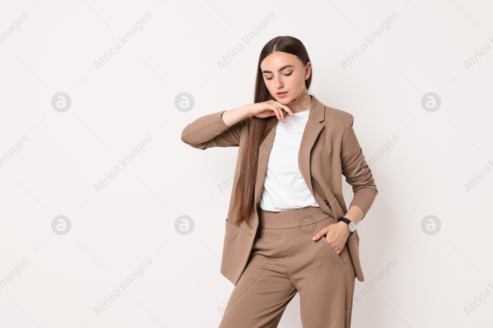 Photo of Beautiful woman in beige suit on white background