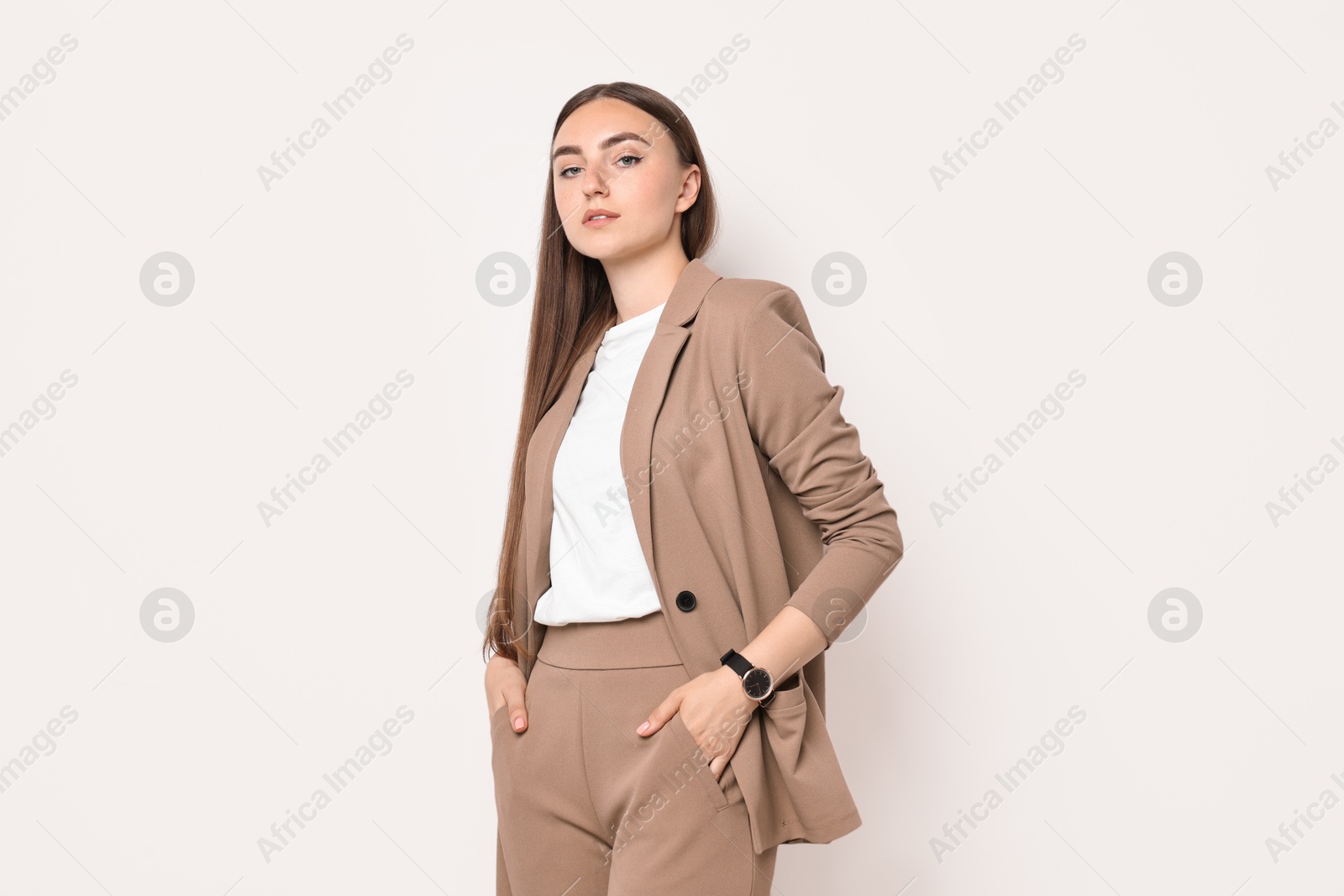 Photo of Beautiful woman in beige suit on white background