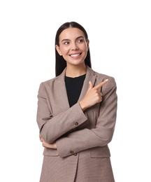 Beautiful woman in beige suit pointing at something on white background