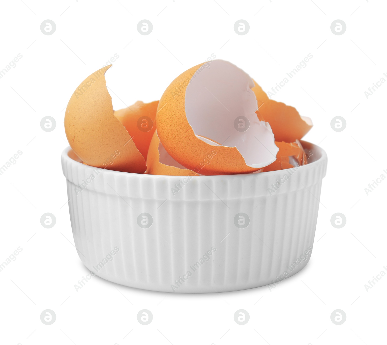 Photo of Broken eggshells in bowl isolated on white