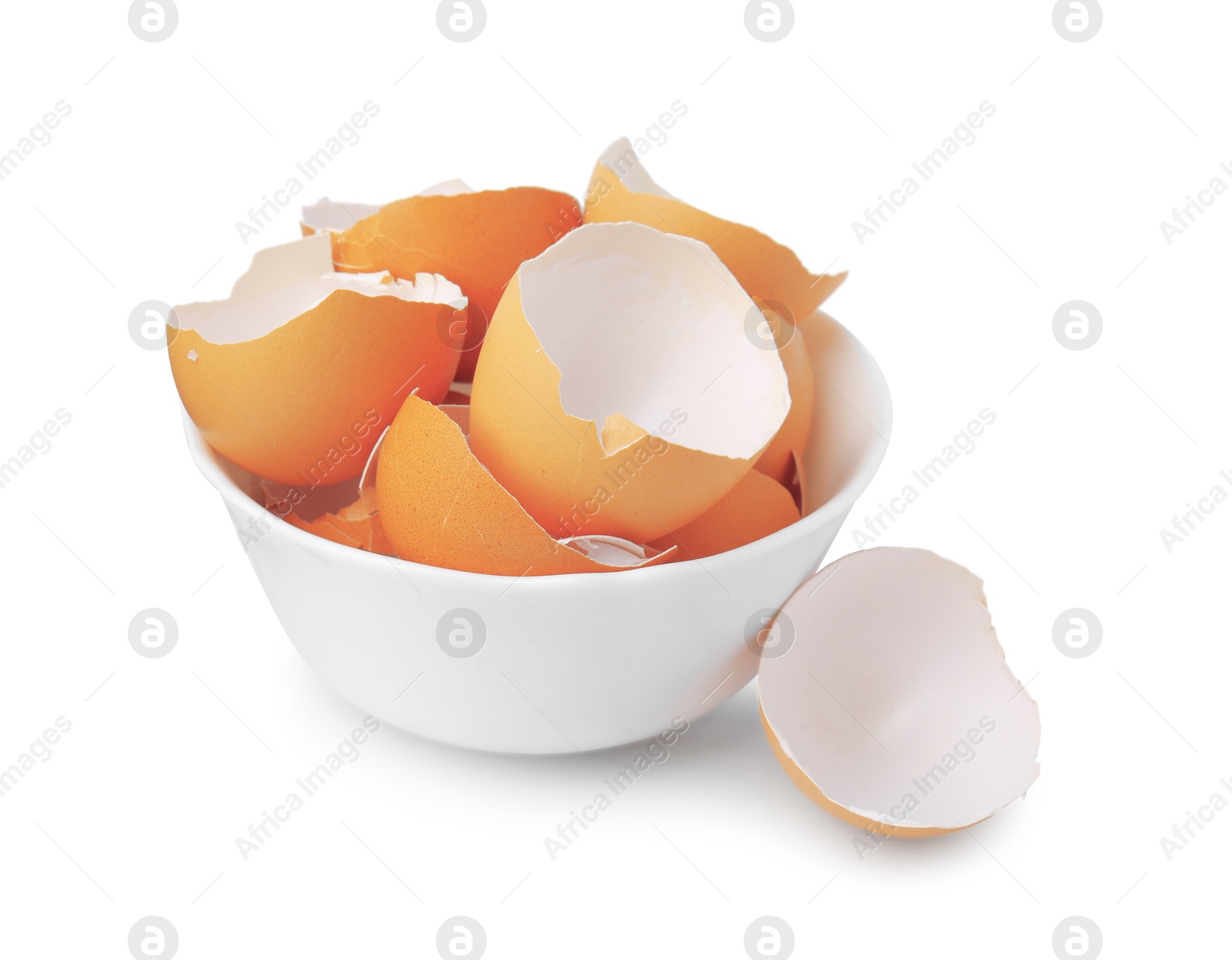 Photo of Broken eggshells in bowl isolated on white