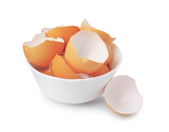 Photo of Broken eggshells in bowl isolated on white