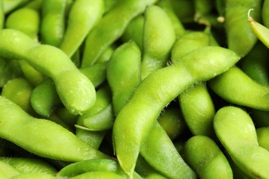 Photo of Fresh edamame pods as background, closeup view