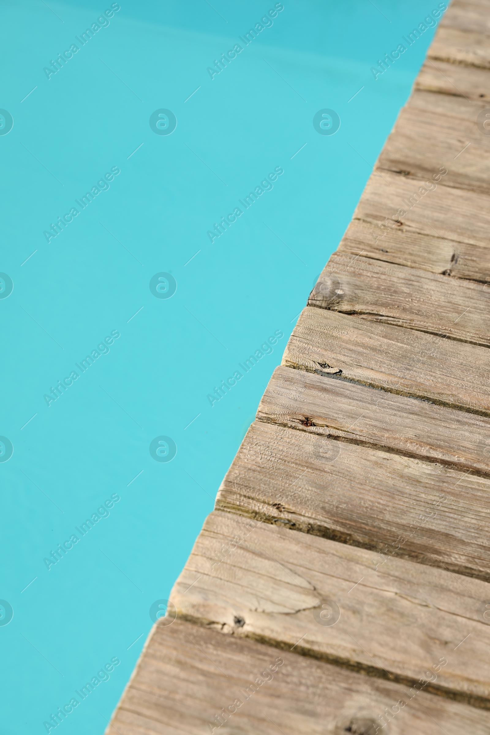 Photo of Wooden desk near outdoor swimming pool at resort