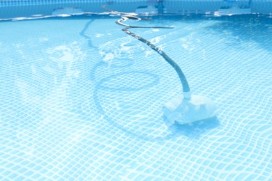 Photo of One robotic cleaner in swimming pool outdoors