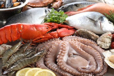 Many different sea food and lemon on table, closeup