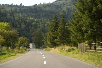 Photo of Beautiful view of green trees and asphalt road in mountains