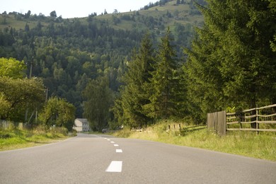 Photo of Beautiful view of green trees and asphalt road in mountains