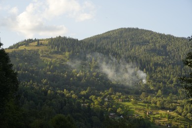 Photo of Picturesque view of mountain village and forest