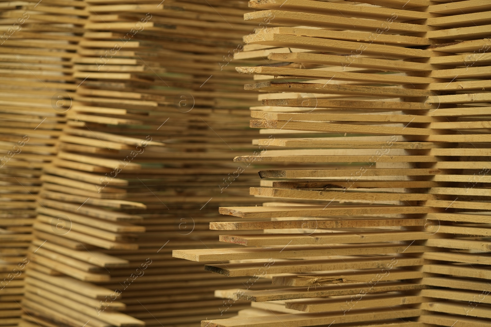 Photo of Stacks of many wooden planks, closeup view