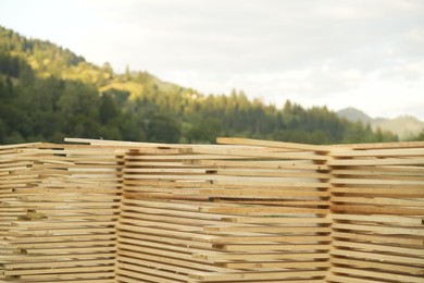 Stacks of many wooden planks in mountains