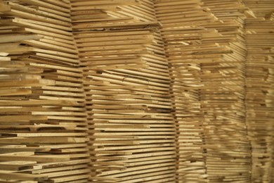 Stacks of many wooden planks, closeup view