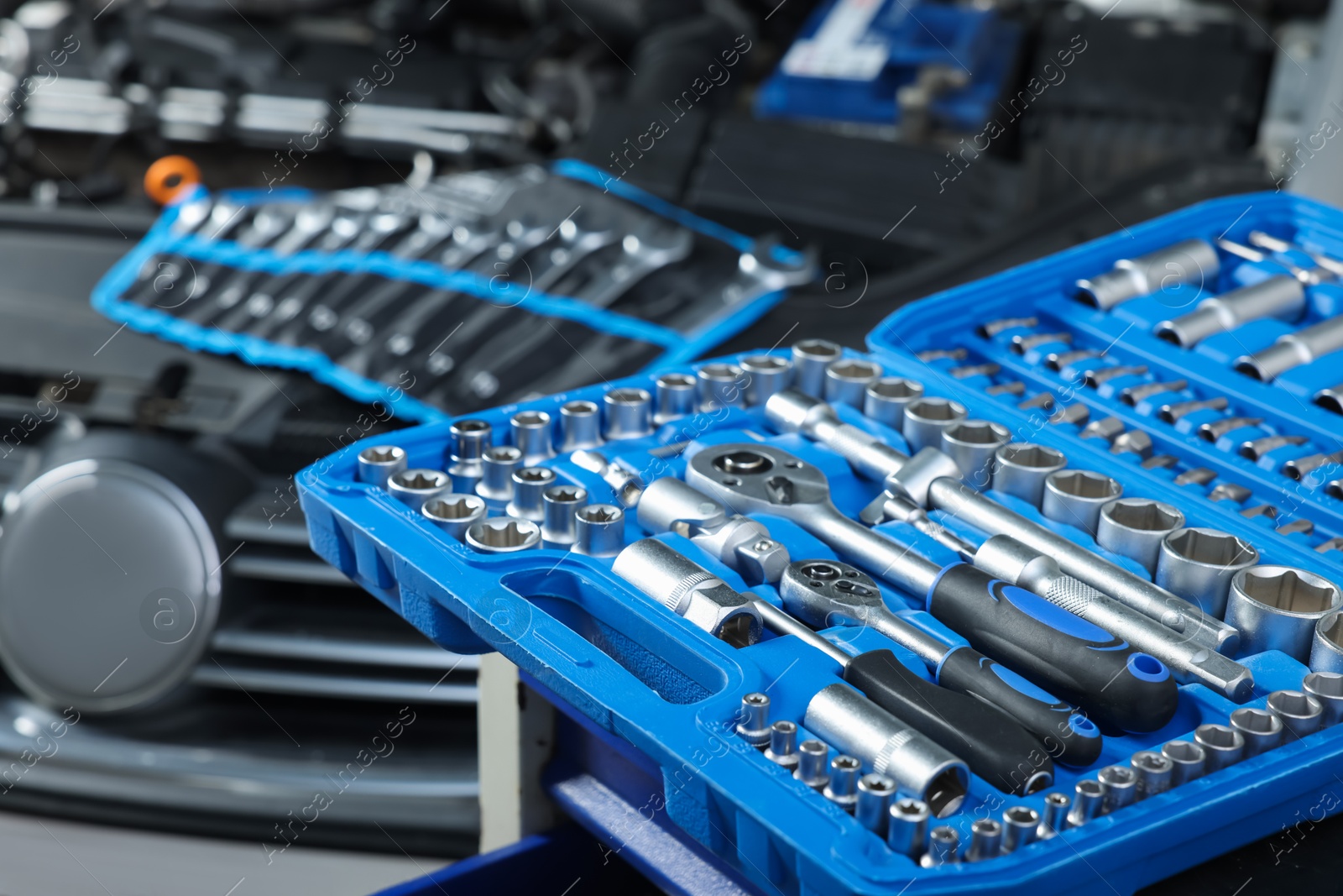 Photo of Set of different auto mechanic's tools at automobile repair shop, closeup