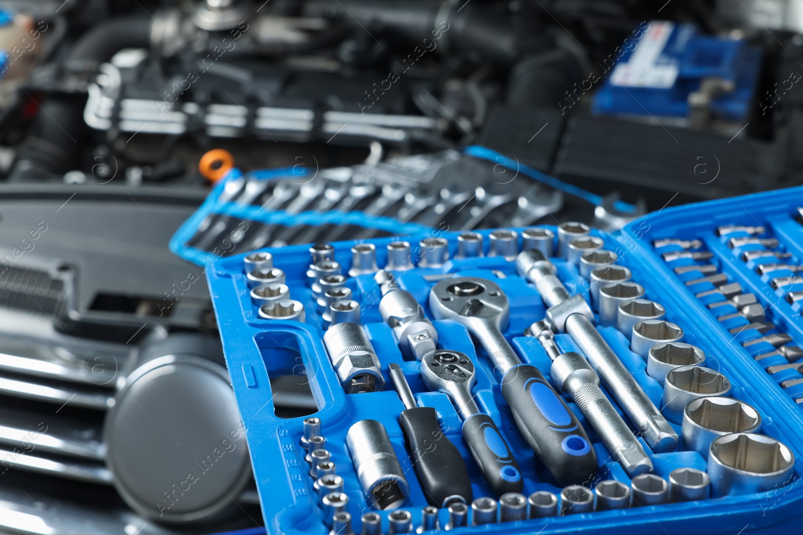 Photo of Set of different auto mechanic's tools at automobile repair shop, closeup