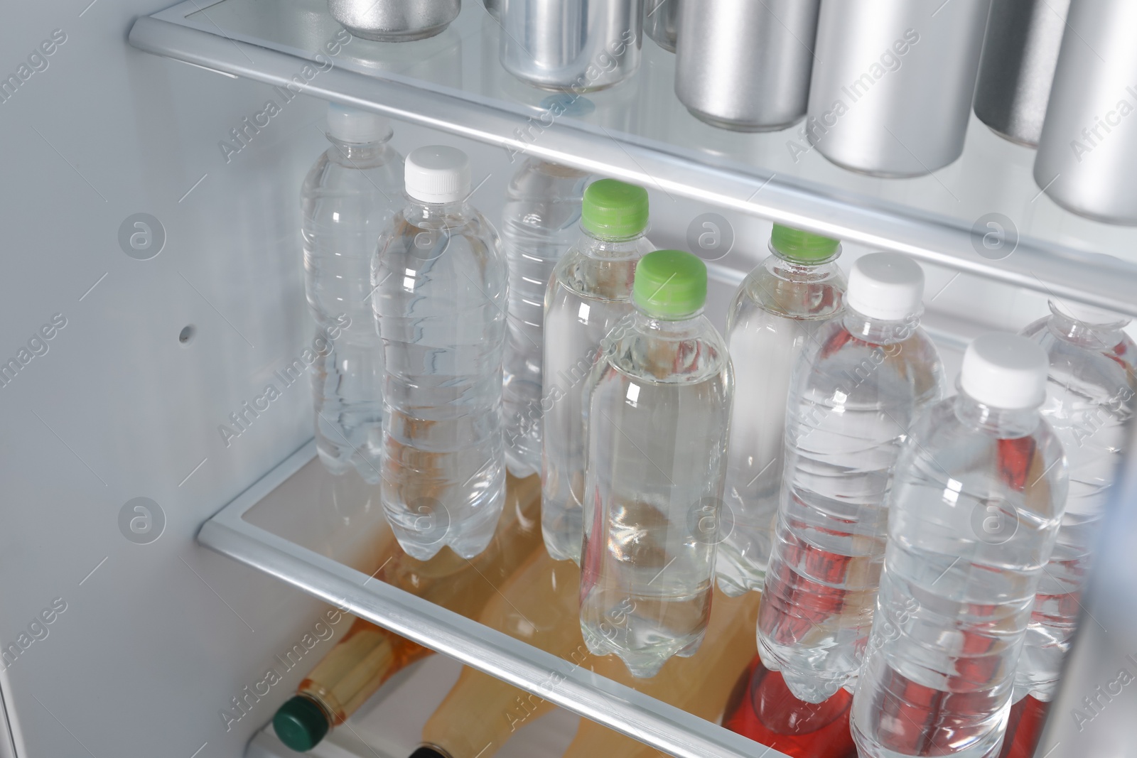 Photo of Many different cold drinks in refrigerator, closeup