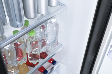 Many different cold drinks in refrigerator, closeup