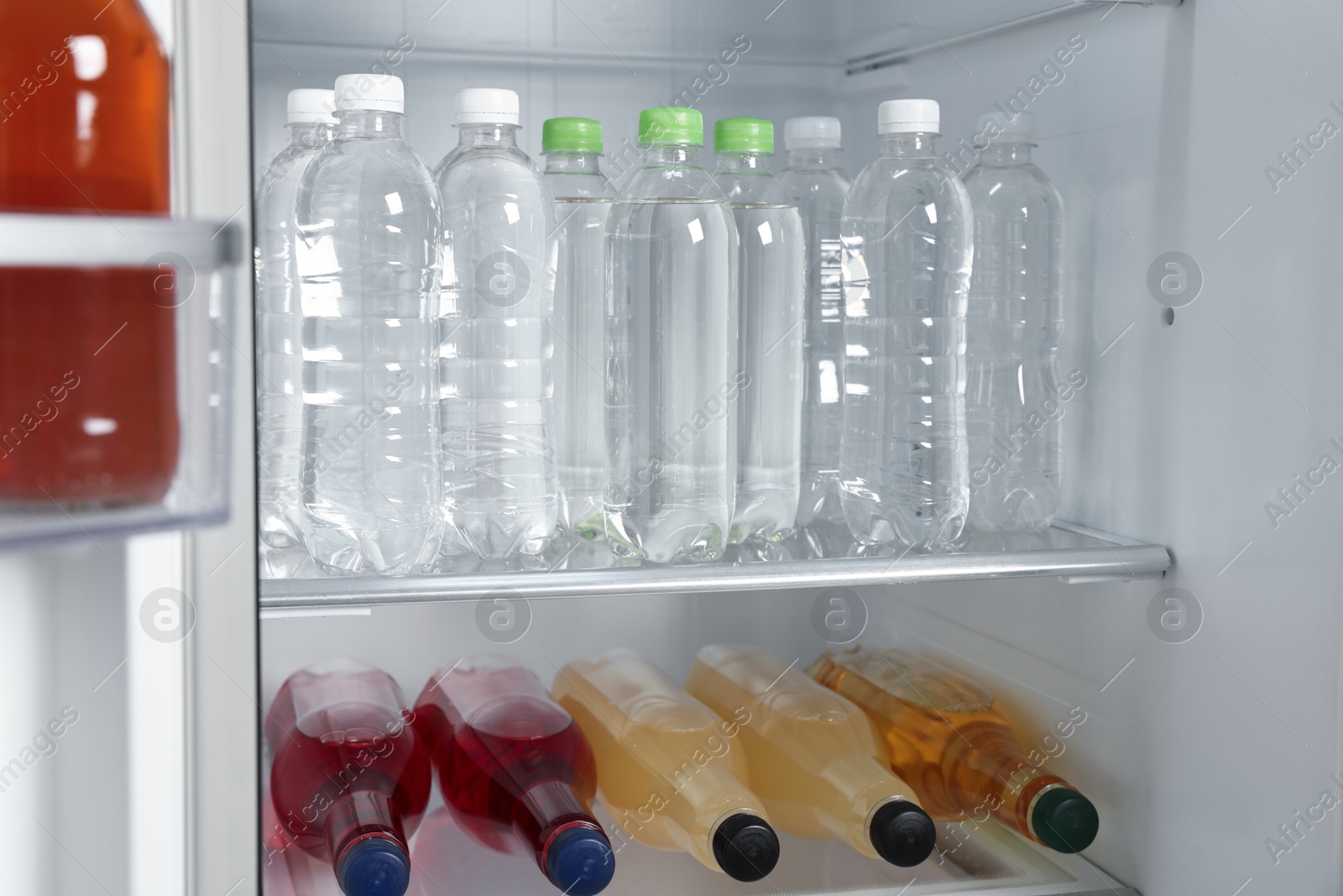 Photo of Many different cold drinks in refrigerator, closeup